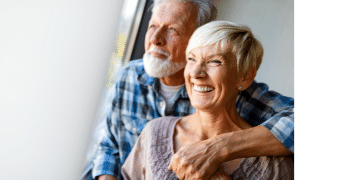 Happy senior couple in love hugging and bonding with true emotions at home